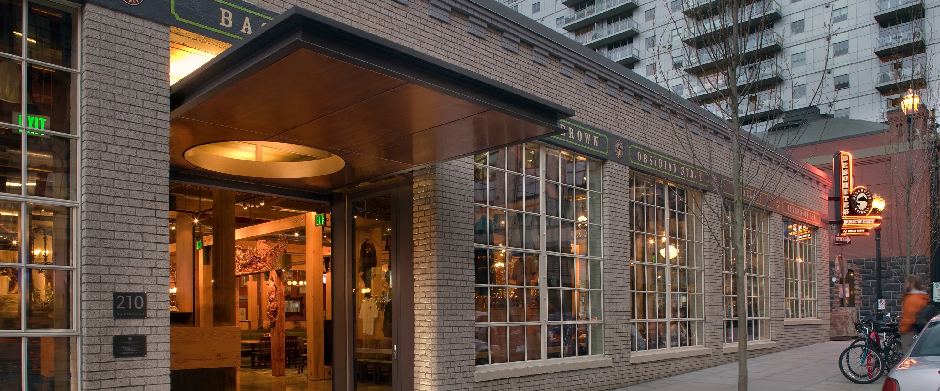 An exterior photograph of the Deschutes Brewing Portland Public House at dusk.
