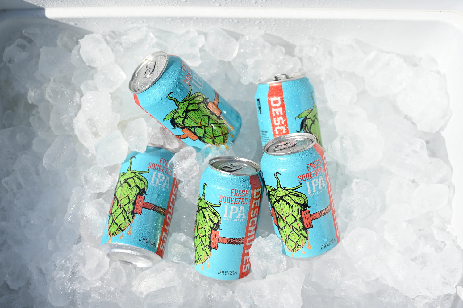 A photograph of six Fresh Squeezed cans in a cooler with ice.