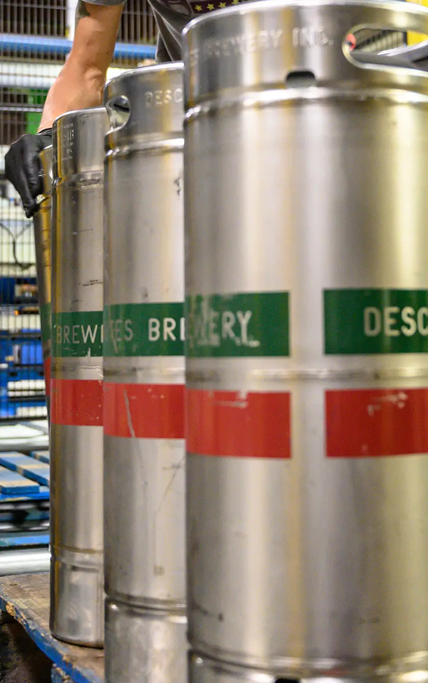 A photograph of several Deschutes kegs on a palette.